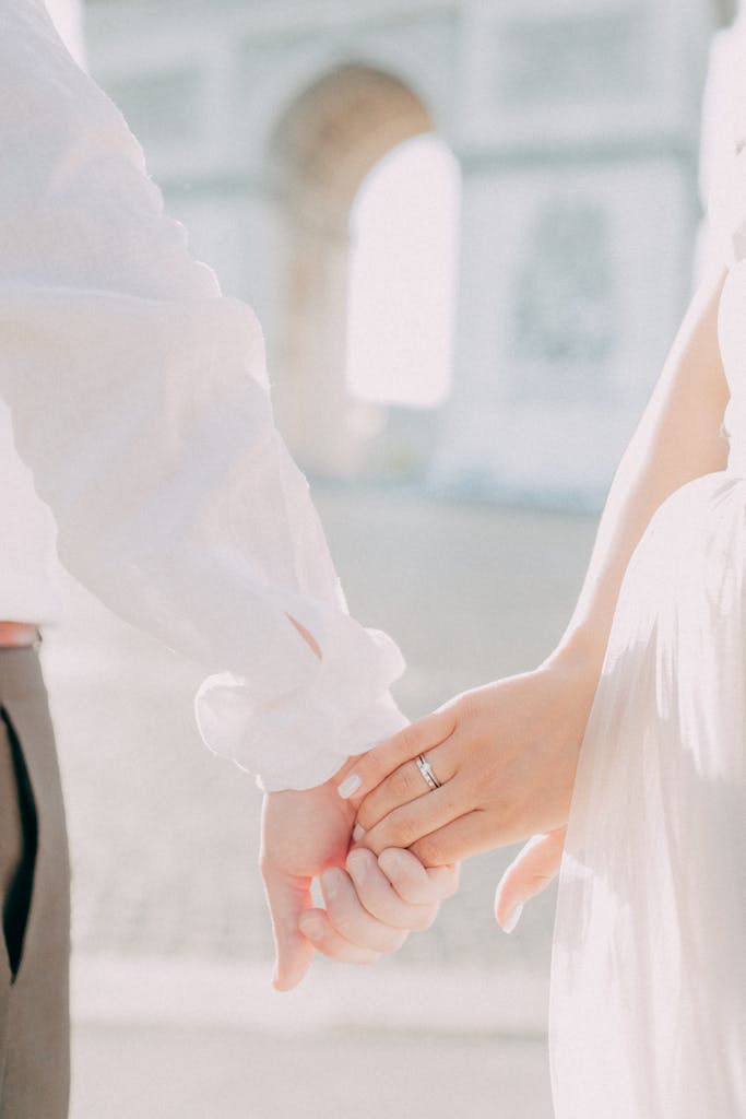A couple holding hands with an iconic landmark in the background, symbolizing love and unity.