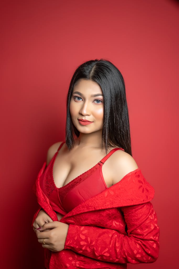 A woman in red dress posing for the camera