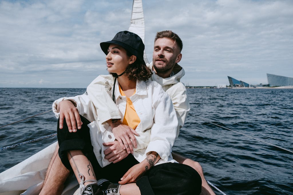 Romantic couple sailing on a yacht, embracing and enjoying the ocean view on a sunny day.
